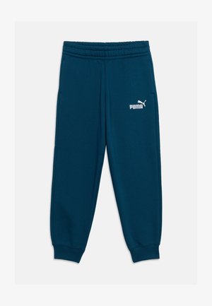 Pantalon de survêtement Puma bleu foncé avec ceinture et poignets élastiques, arborant un logo Puma blanc sur la partie supérieure de la cuisse gauche.