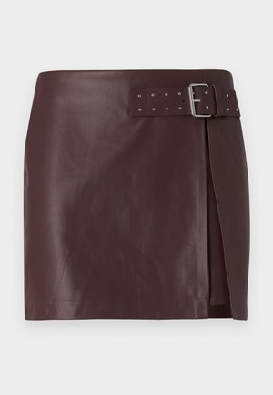 Burgundy faux leather skirt with a belted waist and metallic buckle, featuring a side slit and smooth, polished texture.