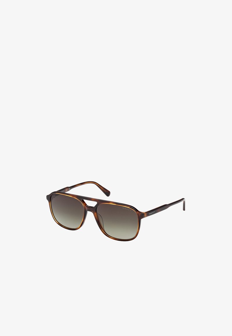 Occhiali da sole tartaruga con lenti sfumate da scure a chiare. Montatura rettangolare elegante con superficie liscia e aste sottili caratterizzate da dettagli del logo.