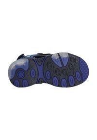 Zool van een schoen met een zwart en paarse rubberen ontwerp, met ronde en hexagonale traction patronen en duidelijke accentgebieden.