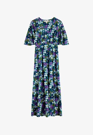 Floral maxi-jurk met een v-hals, korte fladdermouwen en een aansluitende taille. Het materiaal is lichtgewicht met een levendig groen, paars en wit patroon.