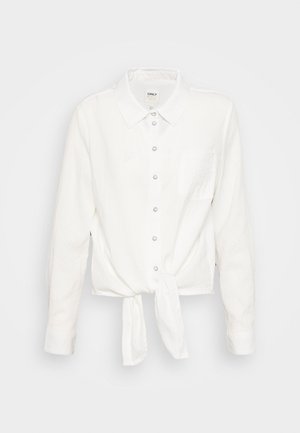 Weiße, langärmelige Bluse mit Kragen und einer Brusttasche. Sie hat ein Knoten-Detail in der Taille und einen strukturierten Stoff.