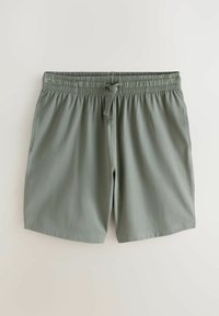 Shorts à taille élastique gris clair avec cordon de serrage et poches latérales, posés à plat sur une surface claire.