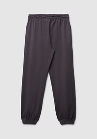 Dunkelgraue Jogginghose aus weichem Stoff, mit einem elastischen Bund und elastischen Bündchen an den Knöcheln. Einfaches, schmuckloses Design.