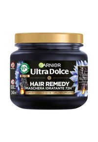 Barattolo nero con coperchio dorato, etichettato "Garnier Ultra Dolce Hair Remedy." Contiene 340 ml. Presenta motivi floreali e naturali. Ingredienti 97% naturali.