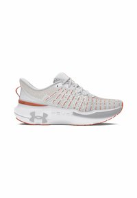 White athletic shoes with a breathable mesh upper featuring orange accents and a textured pattern. Thick white sole with traction grooves.