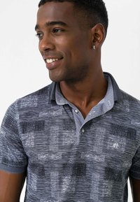 Herre polo shirt i mørkeblå med en struktureret, mønstret design. Har en kontrasterende krave og tre knapper ved halsen.