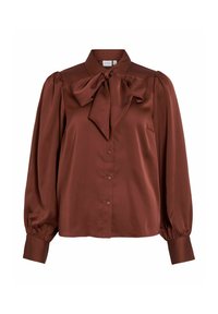 Brūna satīna blūze ar augstu apkakli, pārspīlētu loksnes aksesuāru pie dekoltē, pogu aizdari un pūkainām garām piedurknēm ar elastīgām aprocēm.