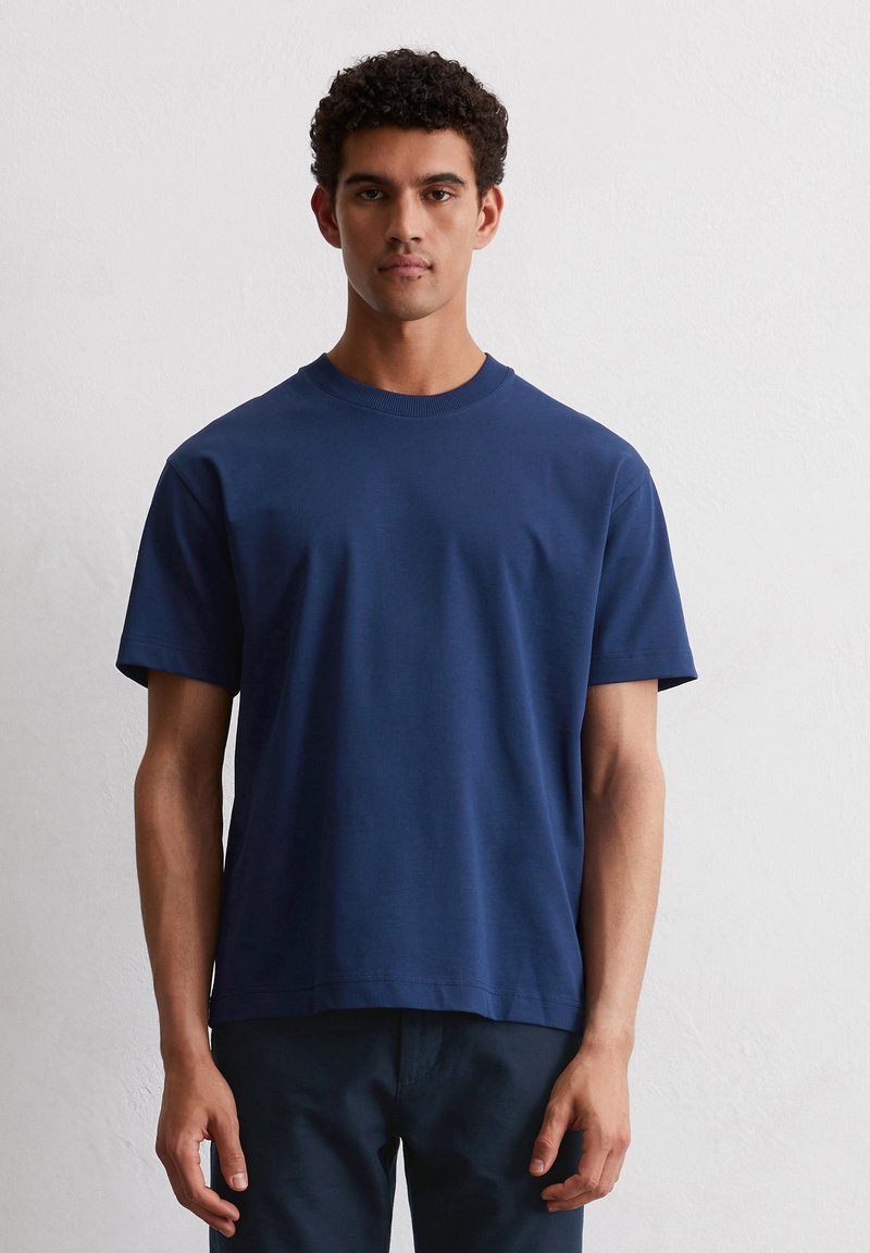 Donkerblauwe T-shirt met korte mouwen, gemaakt van zacht katoen, met een ronde halslijn en een ontspannen pasvorm, zonder zichtbare patronen of accenten.