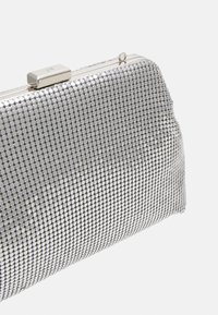 Metallic silver clutch bag covered in small round sequins, featuring a rectangular shape, framed closure, and smooth texture.