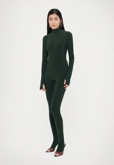 Body ajustado de color verde oscuro con cuello alto, mangas largas y recortes para las manos. Hecho de una tela suave y elástica, diseño ajustado, cobertura completa.