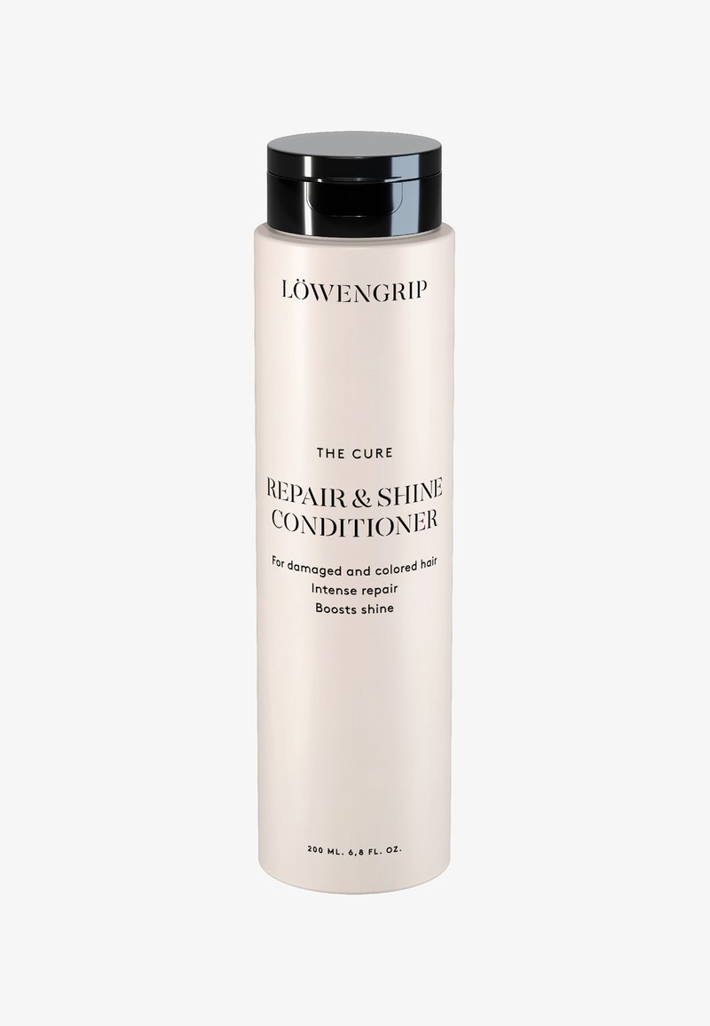 Høy beige flaske med svart kork merket Löwengrip Repair & Shine Conditioner for skadet, farget hår, 200 ml, med intens reparasjon og glansforsterkning.