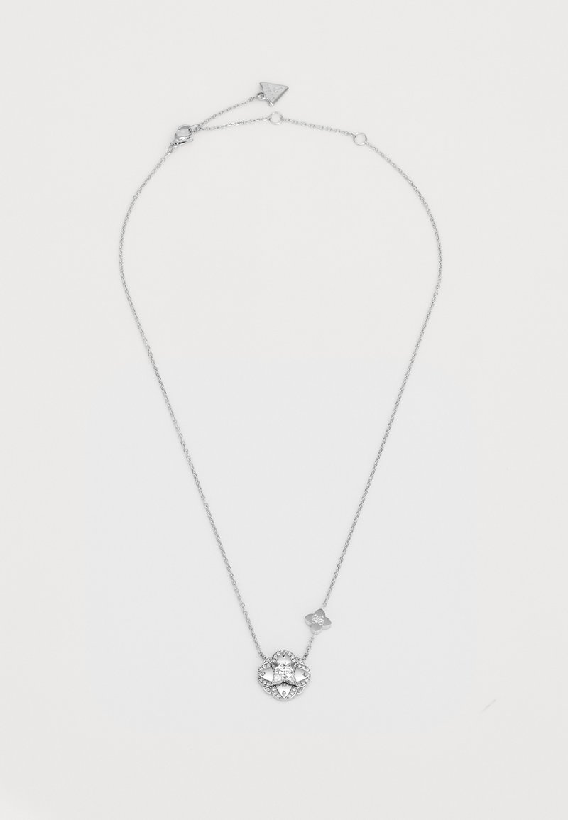 Hõbedane kett, millel on ümmargune ripats keskse selge kiviga, ümbritsetud väiksemate kividega, reguleeritava klambriga.