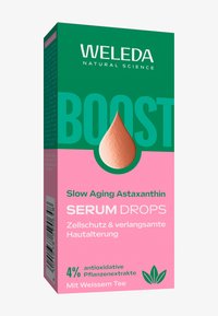 Serum krople Weleda Boost Slow Aging Astaxanthin w pudełku z zielono-różowym wzorem oraz tekstem o roślinnych ekstraktach antyoksydacyjnych.