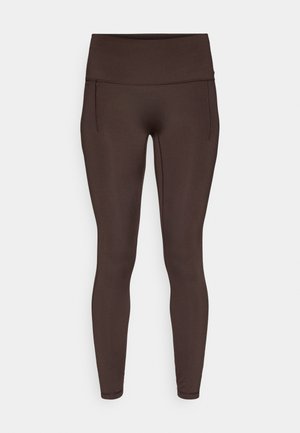 Καφέ κολάν με λείο, ελαστικό ύφασμα, ψηλή μέση και πλαϊνές τσέπες. Εφαρμοστό σχέδιο με ελάχιστες ραφές για άνεση.