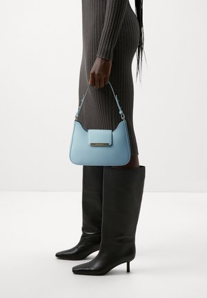 Blue leather handbag with a flap closure, a short strap, and a rectangular shape. The bag features a silver accent on the front.