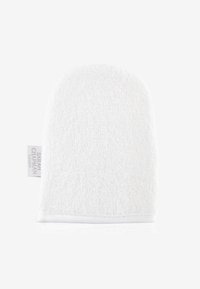Vit bomull exfolierande handske med en struktur yta och en rundad form. Har en liten etikett som visar varumärket.