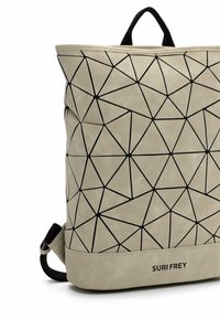 Beige värinen reppu, jossa musta geometrinen kolmionmuotoinen kuvio, musta kangashihnalenkki ja "SURI FREY" -logo alaosassa edessä.