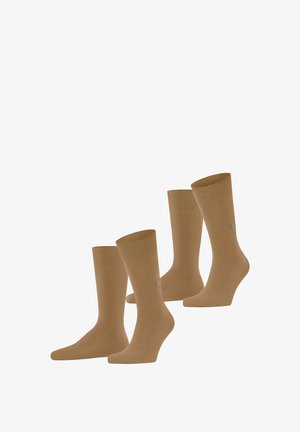 Paires de chaussettes en coton marron avec des bords côtelés et un petit logo argenté sur le côté. Texture lisse, longueur mi-mollet.