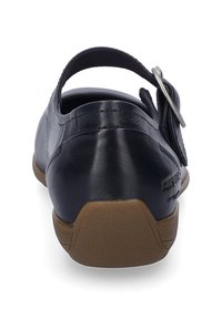 Navy leather shoe with a rounded back, adjustable strap, and a flat rubber sole. Detailed stitching on the upper.