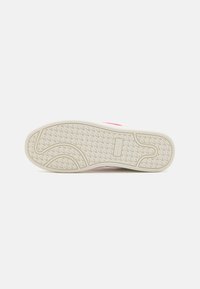 Footwear with a textured rubber sole featuring a wavy pattern, white color, and light pink accents on the sides.