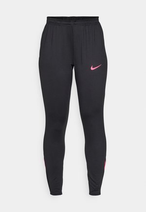Leggings de sport noirs au design ajusté, avec un logo Nike rose sur la cuisse gauche et des accents roses sur les côtés inférieurs. Taille élastique.