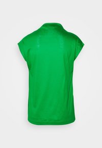 Green short-sleeved t-shirt with a collar and a relaxed fit, featuring a smooth texture and a rounded hemline. No visible patterns.