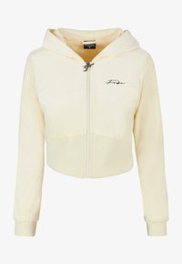 Sudadera corta de felpa amarilla clara con cierre de cremallera, capucha ajustable y un logo bordado en el pecho. Puños y dobladillo acanalados.