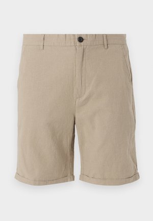 Beige vászon sort, gombos záródással, lapos elejével, oldalsó zsebeivel és felhajtott szegéllyel, légáteresztő, texturált anyagból készült.