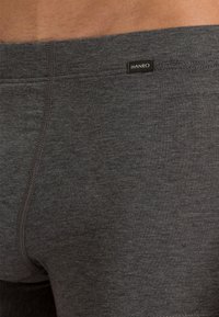 Harmaat boxerit, jotka on valmistettu pehmeästä kankaasta, jossa on sileä pinta ja pieni musta etiketti "HANRO" vyötärökaistassa.