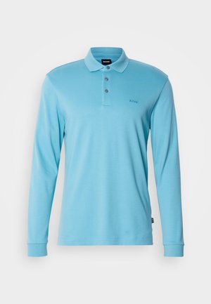 Polo à manches longues bleu clair en matériau doux, doté d'un col classique, de trois boutons et d'un petit logo sur la poitrine.