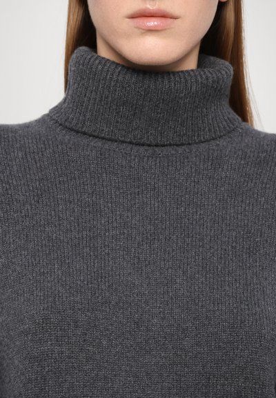 Gray ribbed turtleneck sweater featuring a high collar and soft texture, emphasizing a snug fit around the neck and shoulders.