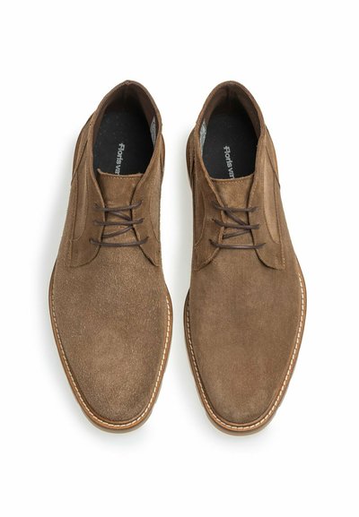 Pair of brown suede men's lace-up ankle boots with rounded toes and visible stitching on white background.