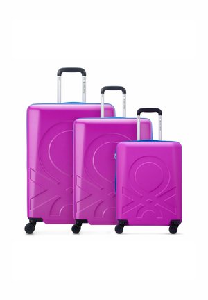 Three purple hard-shell suitcases of varying sizes with embossed designs, featuring blue accents and retractable black handles.