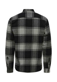 Zwarte en grijze geblokte shirt met lange mouwen, knoopsluiting bij de manchetten en een klassieke kraag. Zachte stof met een gestructureerde afwerking.