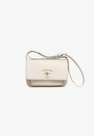 Beige U.S. Polo Assn. Umhängetasche mit verstellbarem Träger und goldfarbenem Logodetail auf der Vorderklappe.