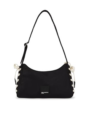 Czarna torba na ramię z regulowanym paskiem, białymi sznurowanymi detalami po bokach oraz małą naszywką z przodu z napisem "KARL LAGERFELD JEANS".