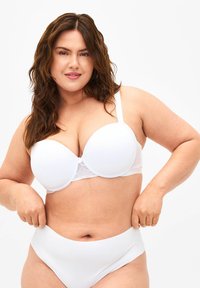 White bra with padded cups and lace detailing at the band, featuring adjustable straps. Paired with white high-waisted underwear.