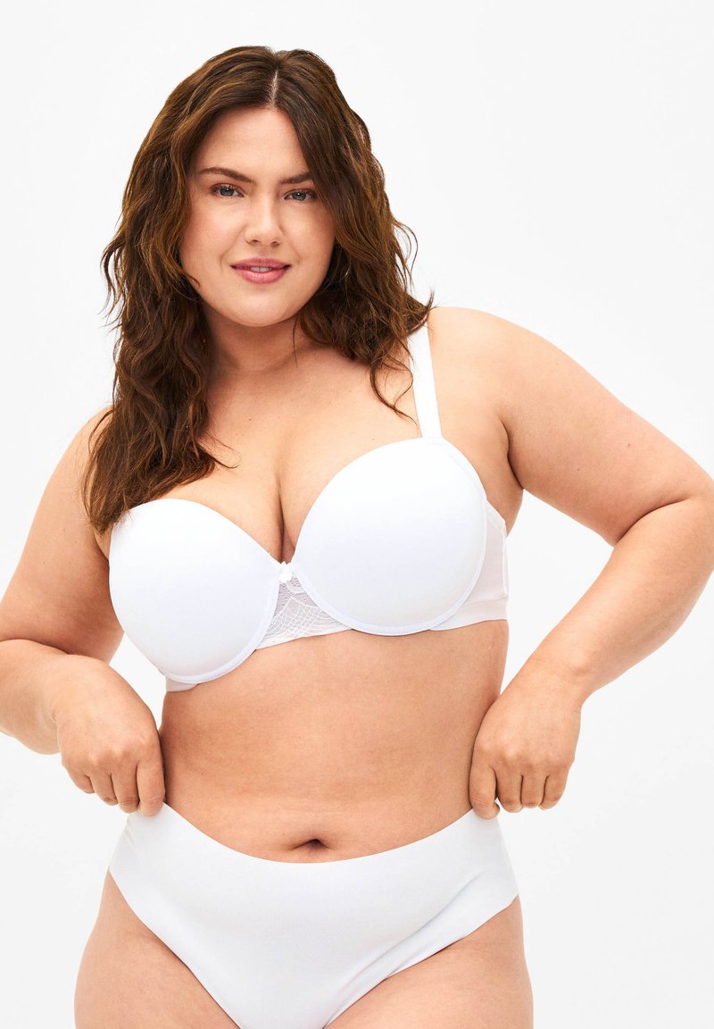 White bra with padded cups and lace detailing at the band, featuring adjustable straps. Paired with white high-waisted underwear.