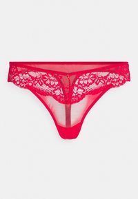 Red lace thong with floral pattern on the waistband, sheer mesh body, and small hardware accent at the front center.
