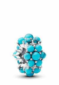 Anello con perle turchesi su base in argento, caratterizzato da pietre rotonde di diverse dimensioni e angolazioni per un effetto a bouquet, decorato con un piccolo diamante.