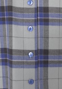 Button-up shirt featuring a gray and blue plaid pattern, made of soft fabric, with light blue plastic buttons and a smooth texture.
