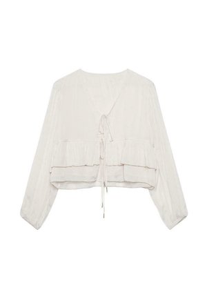 Blusa ligera de color crema con mangas largas, diseño de volantes en capas, cierre con lazo en la parte posterior y textura suave.