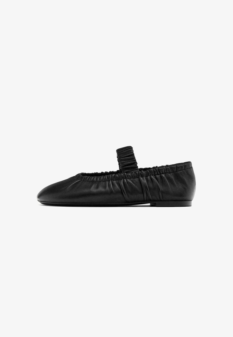 Black leather ballet flat with a gathered elastic band around the opening, low heel, and rounded toe design. Smooth texture.