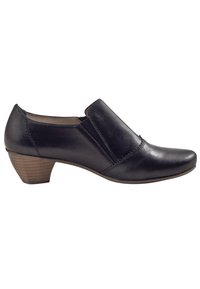 Scarpa in pelle nera con punta arrotondata e pannello elastico laterale; presenta un tacco in legno basso con superficie texture.