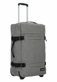 Borsa da viaggio grigia a rotoli con manico superiore, manico in alluminio estensibile, cinghie nere e tasca frontale. Realizzata in tessuto resistente e testurizzato.