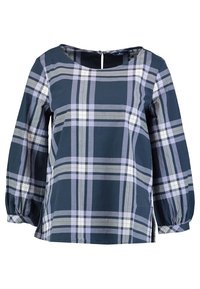 Blusa a quadri blu navy con maniche lunghe e a sbuffo, scollatura a barca e zip sul retro. Presenta motivi a quadri di colore viola chiaro, bianco e grigio.