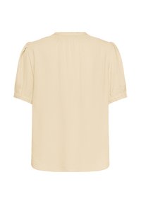 Blusa a maniche corte di un beige chiaro con un motivo testurizzato, spalle arricciate e scollo rotondo. Tessuto morbido con una vestibilità comoda.