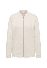 Světlý béžový zipový kabát s texturovanou tkaninou, stojacím límcem a dlouhými rukávy. Přední část zdobí stříbrný zip.