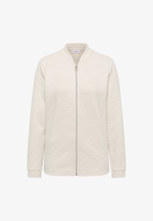 Jasnobeżowa kurtka na zamek błyskawiczny wykonana z teksturowanego materiału, z stojącym kołnierzem i długimi rękawami. Przedni zamek błyskawiczny w srebrnym kolorze.